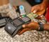a person holding a credit card in their hand