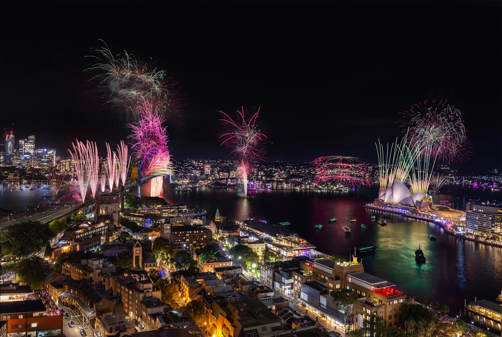 Fireworks are lit up over a city at night
