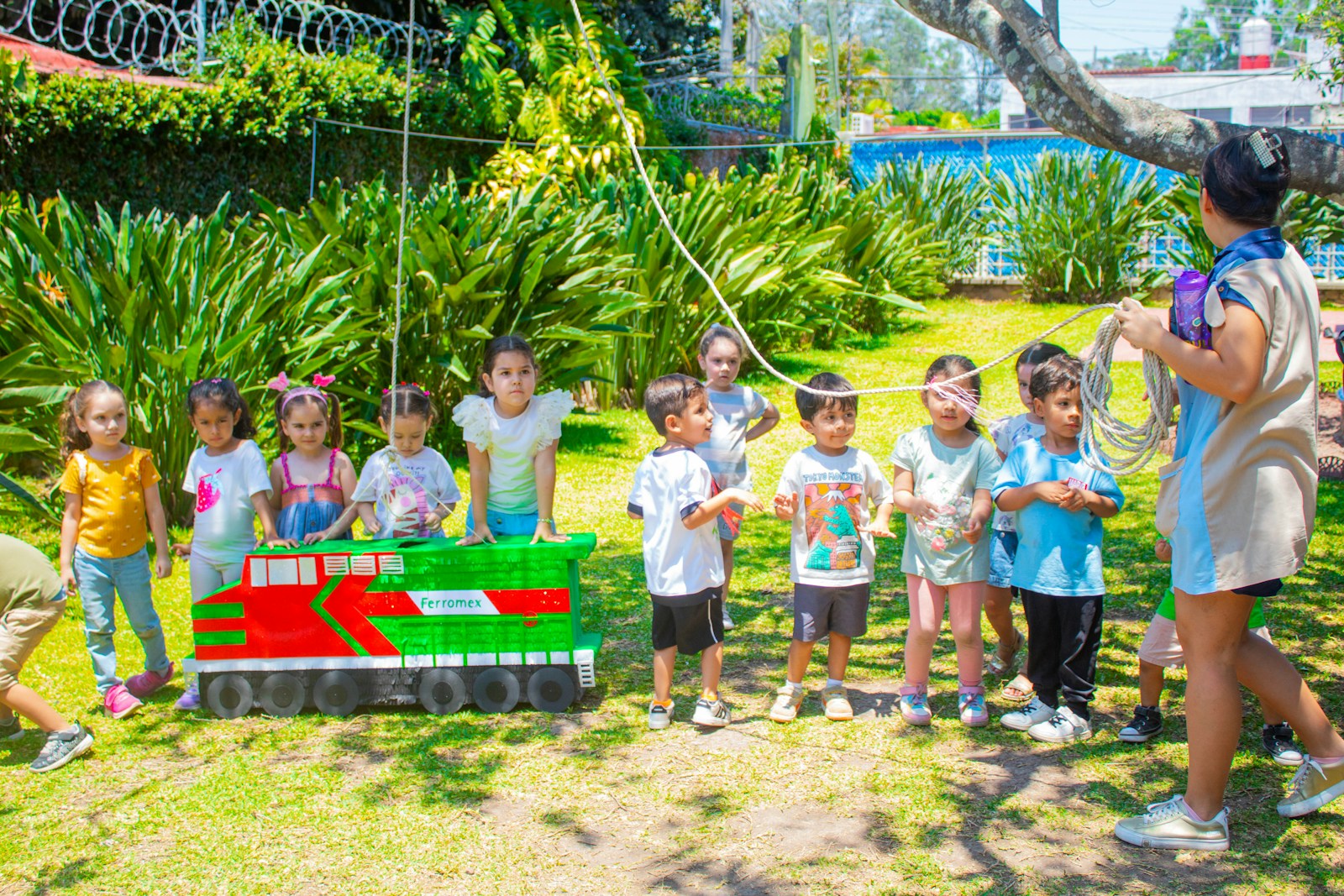 a group of children standing in front of a train