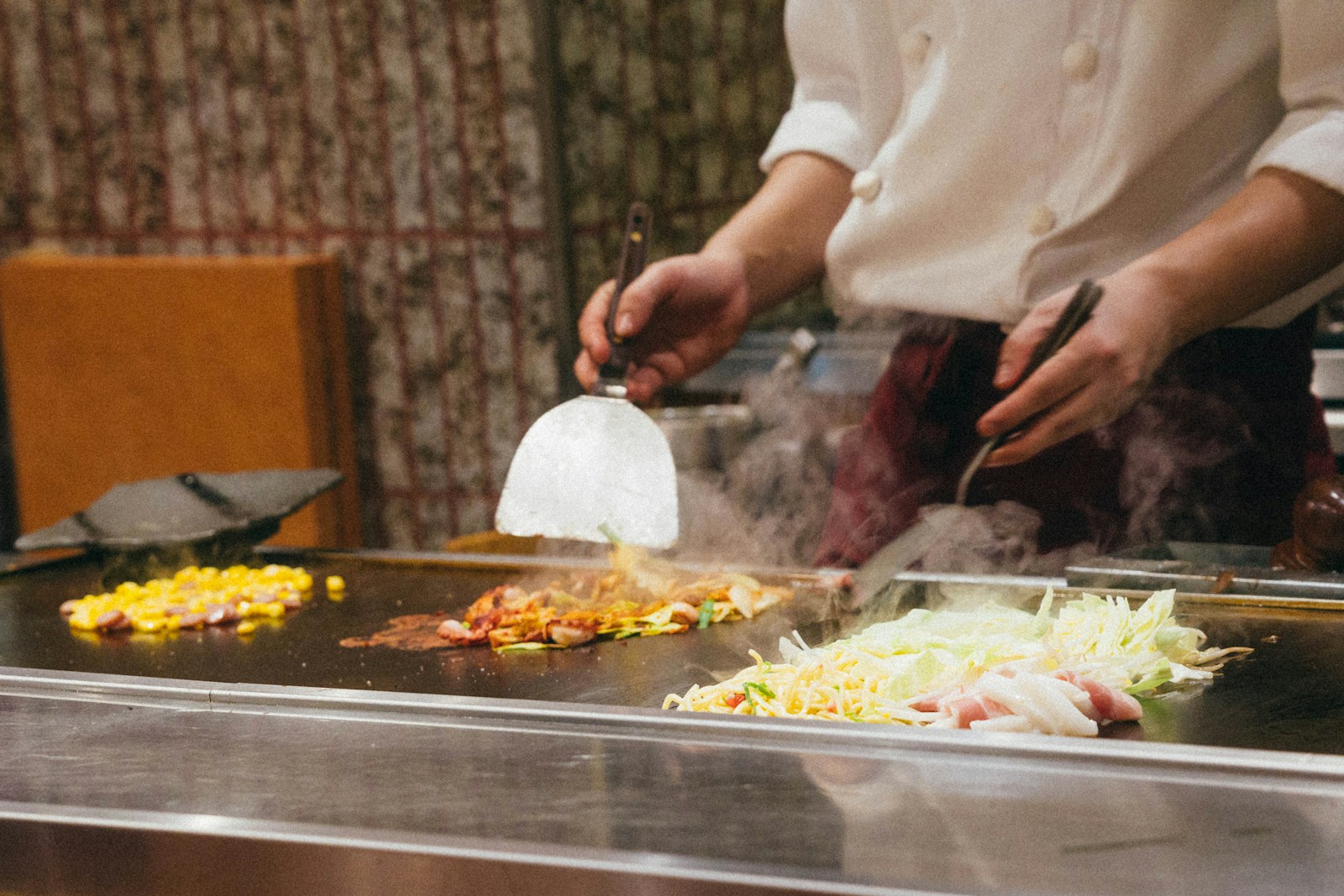 A chef preparing food in a restaurant kitchen